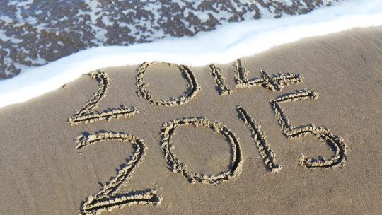 beach shore etch with 2014 and 2015 texts during daytime